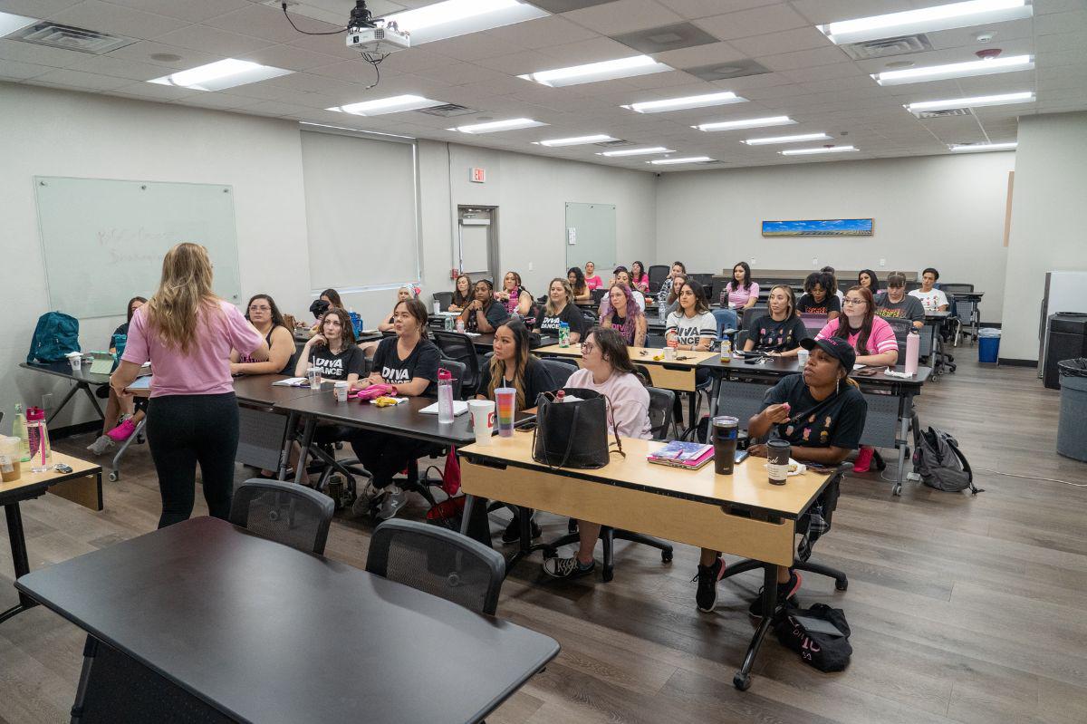 Group of DivaDance owners and instructors in a classroom during a training session.